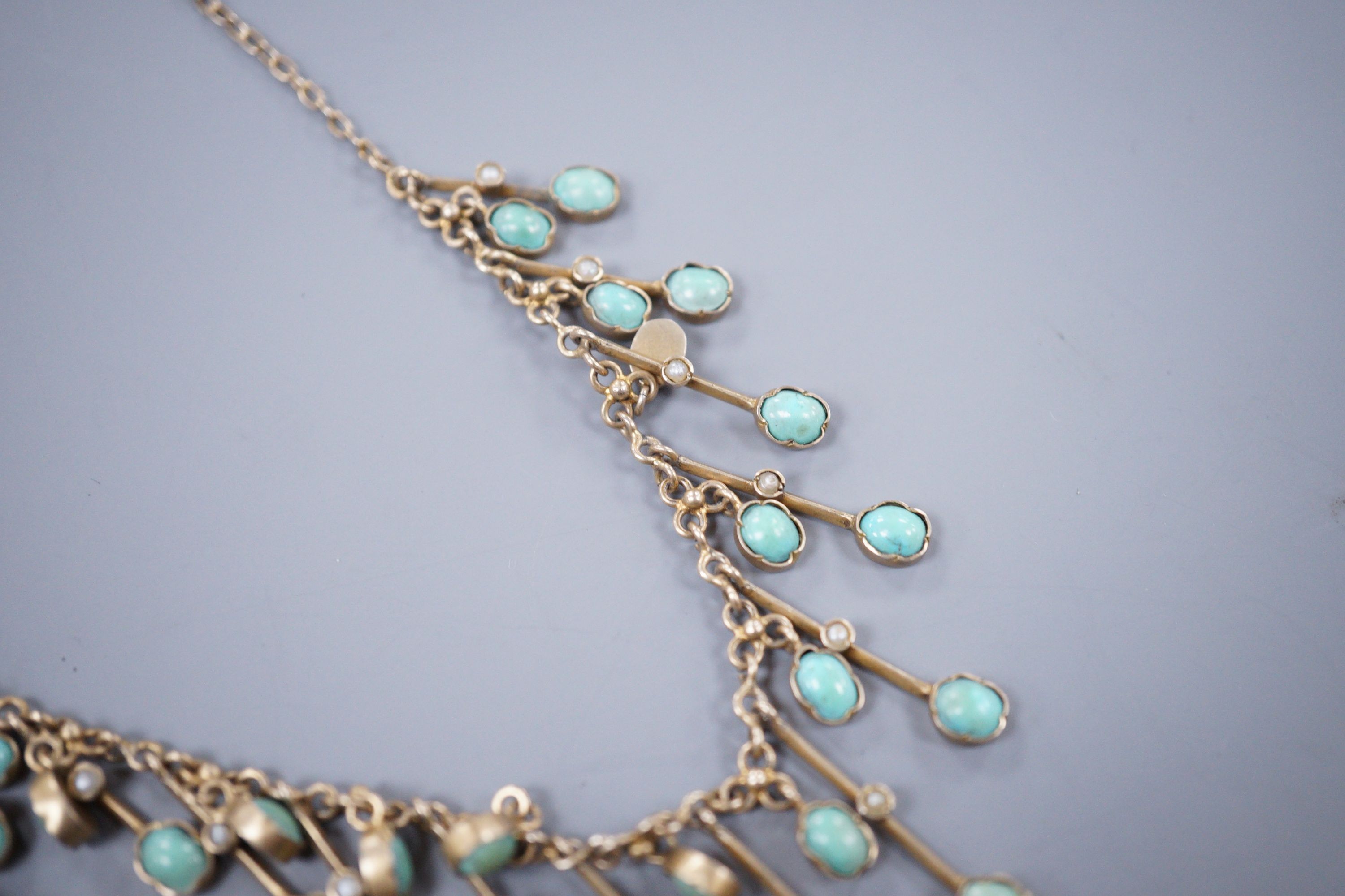 A Continental gem set white metal Hand of Fatima pendant, and a base metal turquoise set fringe necklace